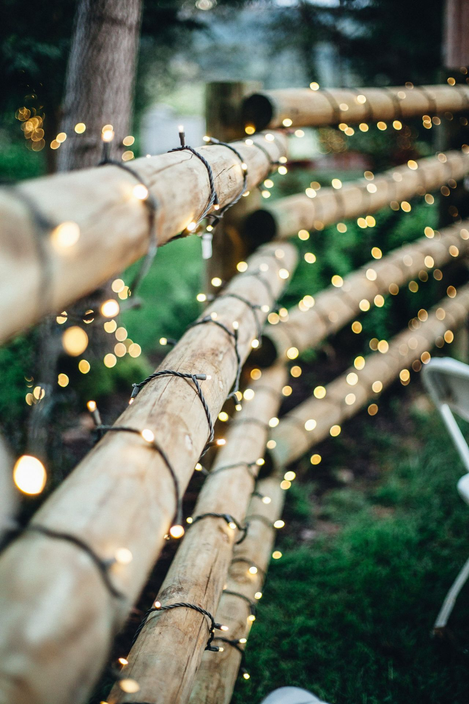brown bamboo fence with string lights